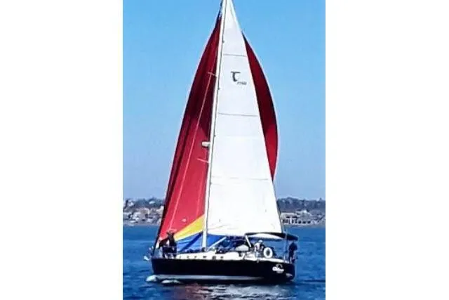 Slide: The Image of Sailboat Tartan 3700, 2002 model, with red and white sails on open water. - 95