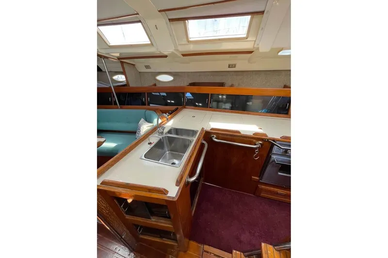 Slide: The Image of Interior of 1986 Hunter Legend 45 yacht with kitchen and seating area. - 12