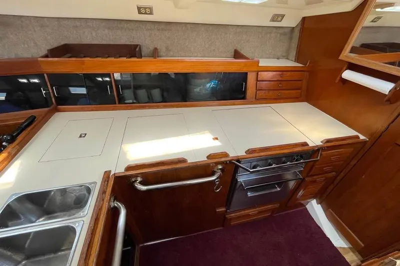 Slide: The Image of 1986 Hunter Legend 45 yacht kitchen with wood cabinetry and modern appliances. - 13