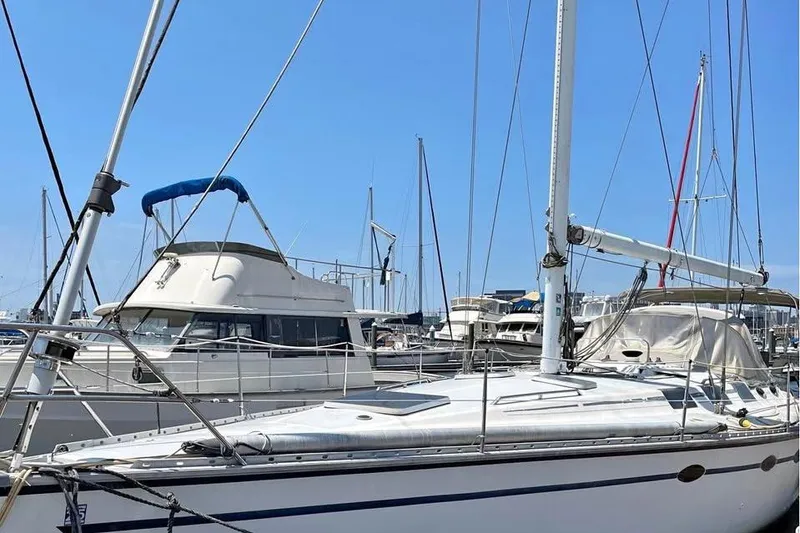 Slide: The Image of 1986 Hunter Legend 45 sailboat docked in a marina under clear blue skies. - 2