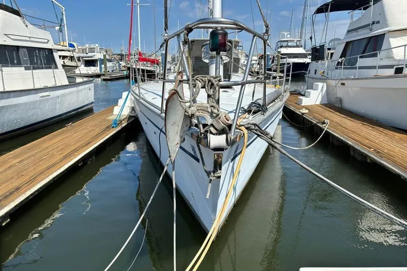 Slide: The Image of 1986 Hunter Legend 45 sailboat docked at a marina, surrounded by other boats. - 3