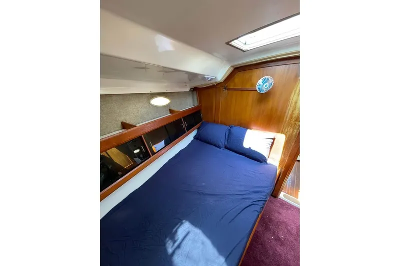 Slide: The Image of Interior cabin of 1986 Hunter Legend 45 sailboat with cozy bed and wooden paneling. - 4