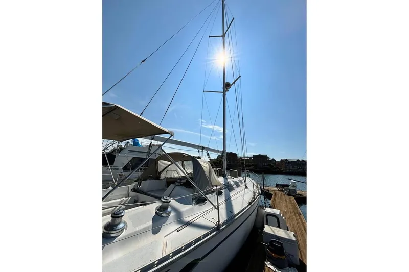 Slide: The Image of 1986 Hunter Legend 45 sailboat docked under clear blue sky. - 7