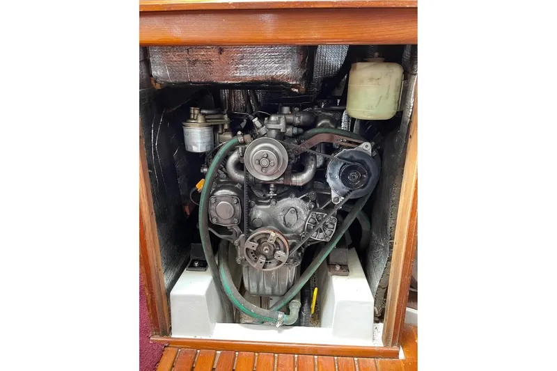 Slide: The Image of Engine compartment of a 1986 Hunter Legend 45 sailboat, showcasing mechanical components. - 9