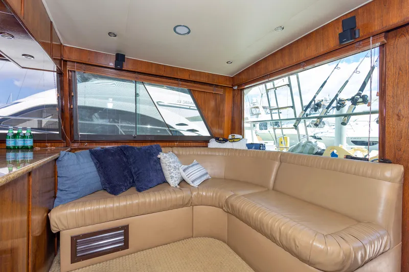 Slide: The Image of Luxurious interior of 1987 Hatteras 52 Convertible yacht with leather seating and large windows. - 100