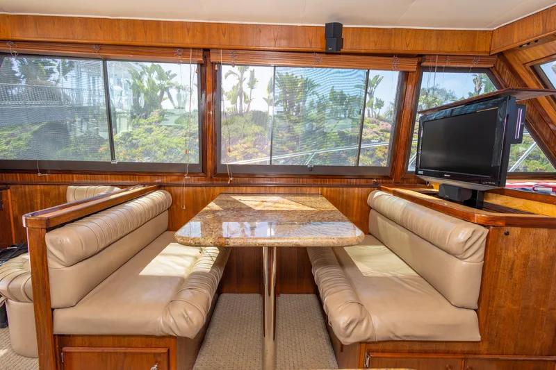 Slide: The Image of Interior of 1987 Hatteras 52 Convertible yacht with dining area and TV. - 101