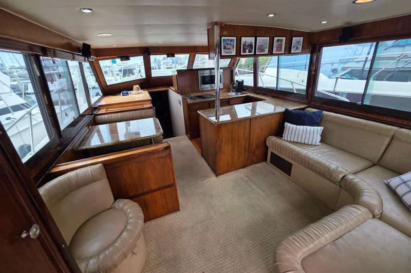 Slide: The Image of Interior of 1987 Hatteras 52 Convertible yacht with luxurious seating and wooden finishes. - 11