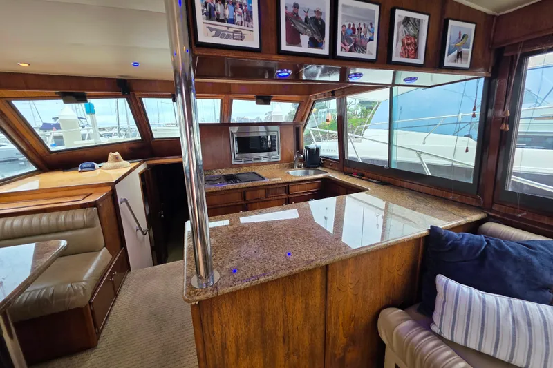 Slide: The Image of Interior of 1987 Hatteras 52 Convertible yacht with wood finishes and granite countertops. - 13