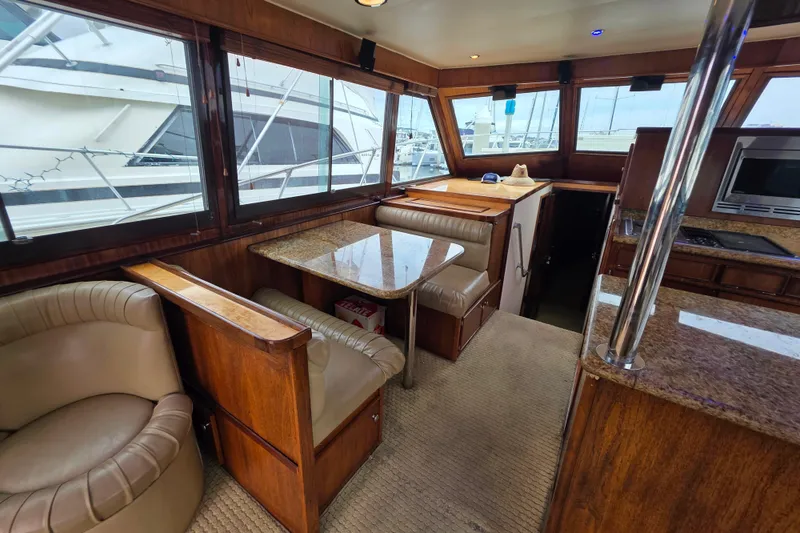 Slide: The Image of Interior of 1987 Hatteras 52 Convertible yacht with dining area and kitchen. - 15