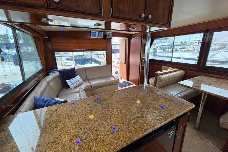 Slide: The Image of Interior of 1987 Hatteras 52 Convertible yacht with luxurious seating and granite countertops. - 16