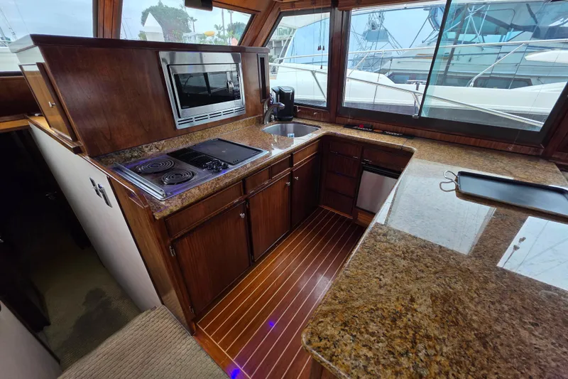Slide: The Image of Luxurious kitchen interior of 1987 Hatteras 52 Convertible yacht with granite countertops. - 19