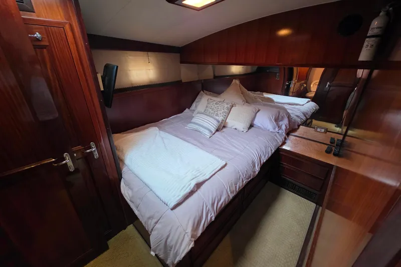 Slide: The Image of Luxurious cabin interior of 1987 Hatteras 52 Convertible yacht with cozy bedding. - 22