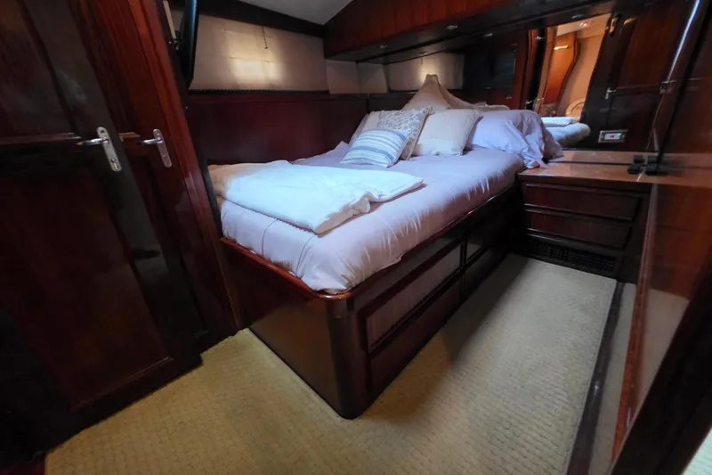 Slide: The Image of Luxurious cabin interior of 1987 Hatteras 52 Convertible yacht with cozy bedding. - 28