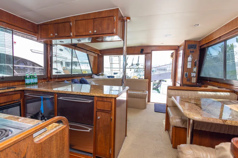 Slide: The Image of Interior of 1987 Hatteras 52 Convertible yacht with wood finishes and granite countertops. - 3