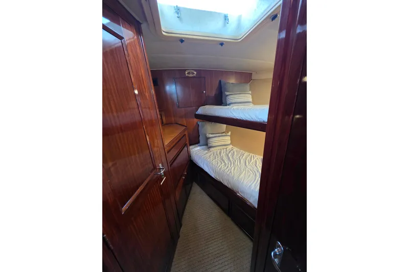 Slide: The Image of Interior of 1987 Hatteras 52 Convertible yacht with wooden bunk beds. - 30