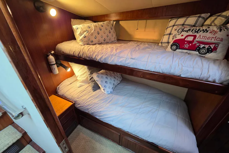 Slide: The Image of Cozy bunk beds in 1987 Hatteras 52 Convertible yacht cabin with nautical decor. - 33