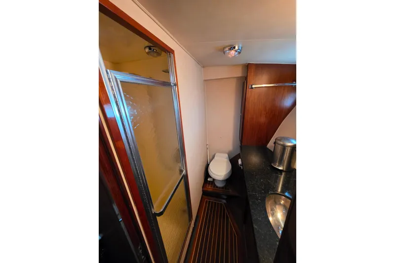 Slide: The Image of 1987 Hatteras 52 Convertible yacht bathroom with shower, toilet, and sink. - 39