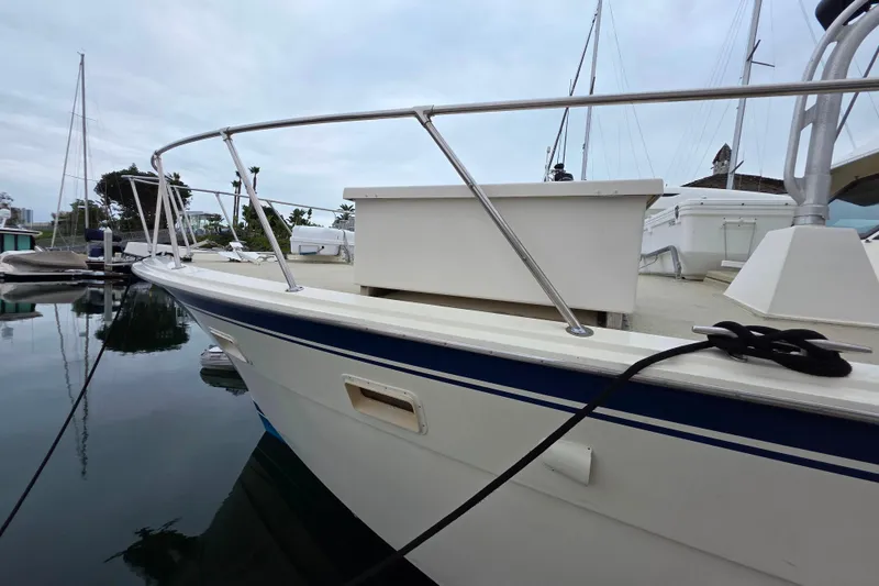 Slide: The Image of 1987 Hatteras 52 Convertible yacht docked at marina, side view. - 40
