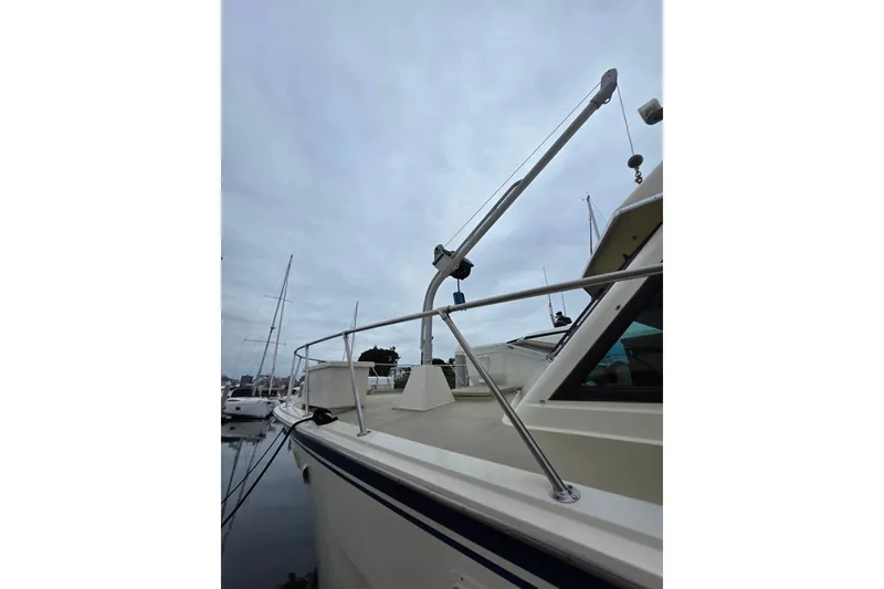 Slide: The Image of 1987 Hatteras 52 Convertible yacht docked, showcasing sleek design and sturdy railings. - 41