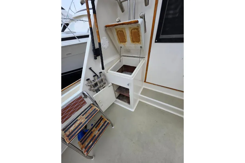 Slide: The Image of 1987 Hatteras 52 Convertible fishing station with storage compartments and rod holders. - 43