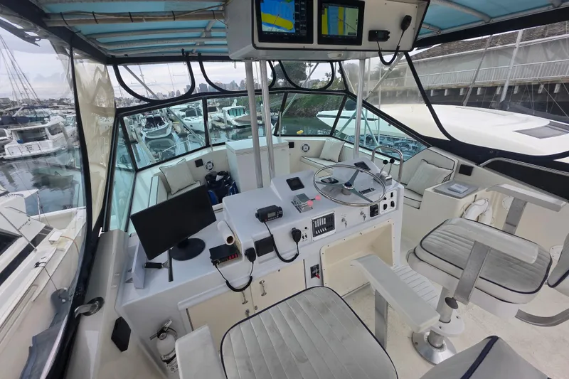 Slide: The Image of Cockpit of 1987 Hatteras 52 Convertible yacht with navigation equipment and seating. - 53
