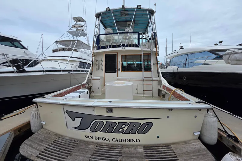 Slide: The Image of 1987 Hatteras 52 Convertible yacht docked in San Diego marina. - 6