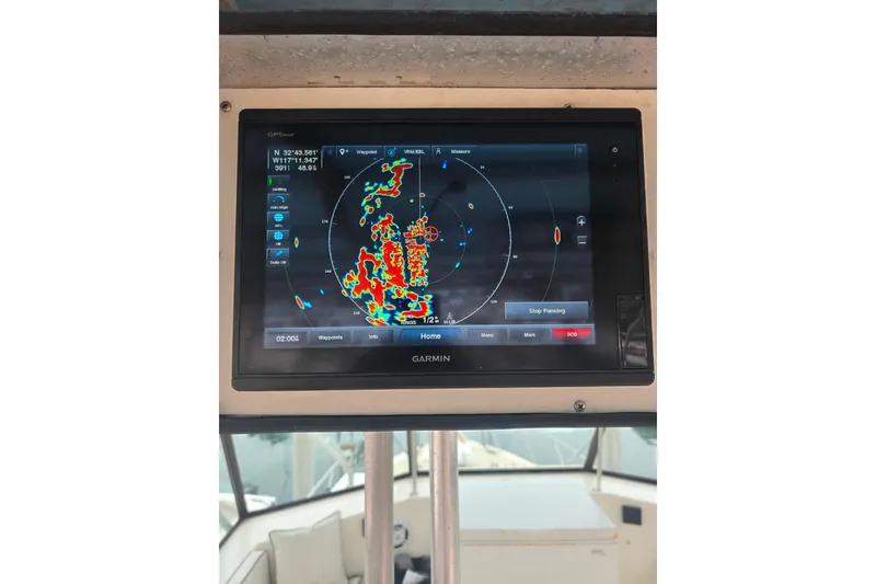 Slide: The Image of Garmin navigation display on 1987 Hatteras 52 Convertible boat, showing radar data. - 62
