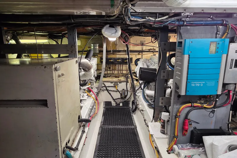 Slide: The Image of Engine room of a 1987 Hatteras 52 Convertible yacht, showcasing equipment and wiring. - 65