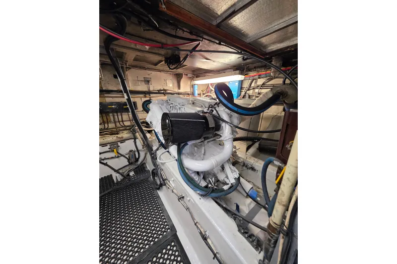 Slide: The Image of Engine room of 1987 Hatteras 52 Convertible yacht, showcasing mechanical components. - 66
