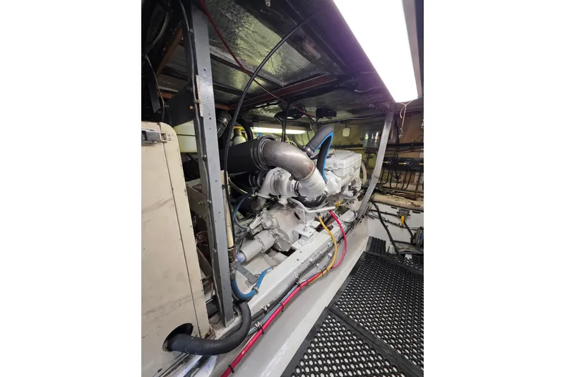 Slide: The Image of Engine room of 1987 Hatteras 52 Convertible yacht, showcasing mechanical components. - 67