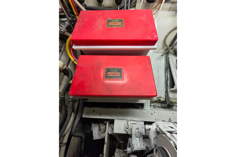 Slide: The Image of Red battery boxes in the engine room of a 1987 Hatteras 52 Convertible yacht. - 68