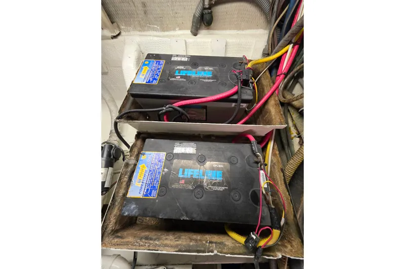 Slide: The Image of Batteries in 1987 Hatteras 52 Convertible engine room with Lifeline labels and wiring. - 69