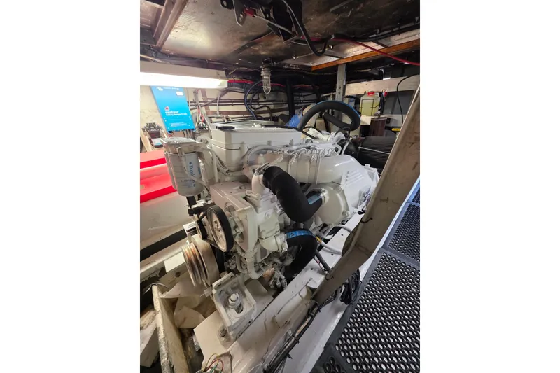 Slide: The Image of Engine room of 1987 Hatteras 52 Convertible yacht, showcasing a well-maintained engine. - 73