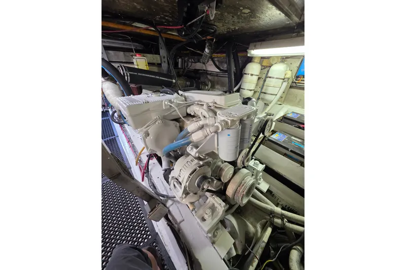 Slide: The Image of Engine room of a 1987 Hatteras 52 Convertible yacht, showcasing mechanical components. - 74