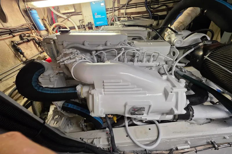 Slide: The Image of Engine room of a 1987 Hatteras 52 Convertible yacht, showcasing detailed machinery. - 75