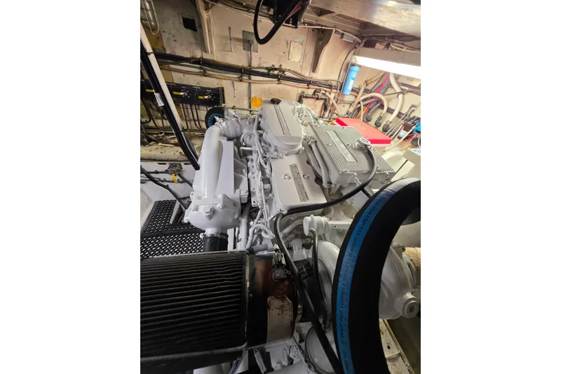Slide: The Image of Engine room of 1987 Hatteras 52 Convertible yacht, showcasing detailed machinery and components. - 76