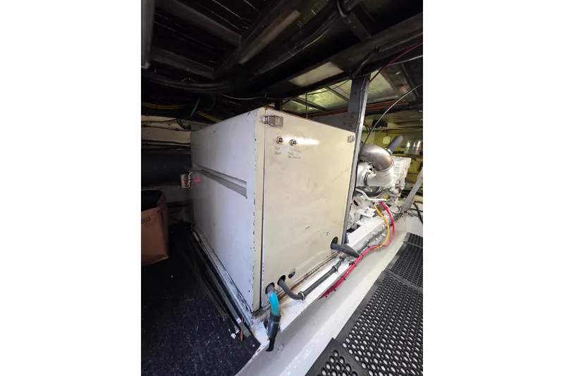 Slide: The Image of Engine room of 1987 Hatteras 52 Convertible yacht, featuring machinery and wiring. - 79