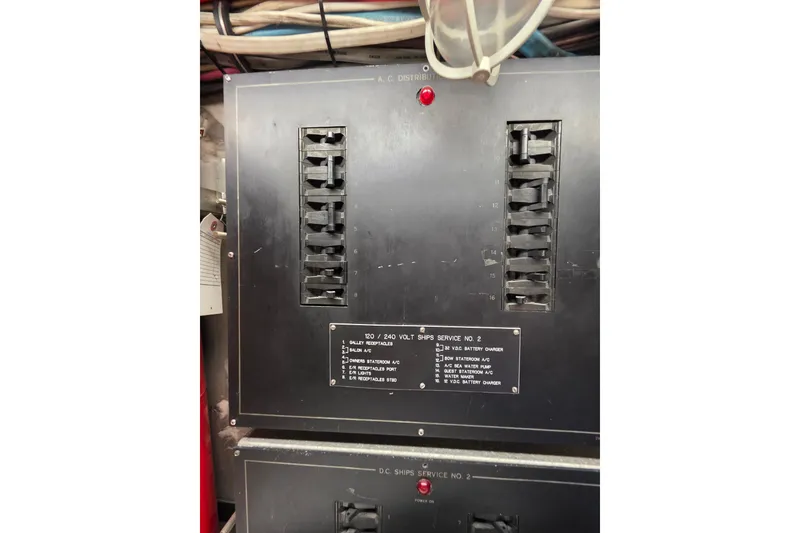 Slide: The Image of Electrical panel on a 1987 Hatteras 52 Convertible boat, showing circuit breakers and wiring. - 81