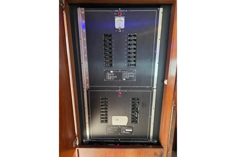 Slide: The Image of Electrical panel on 1987 Hatteras 52 Convertible yacht, featuring circuit breakers and controls. - 83