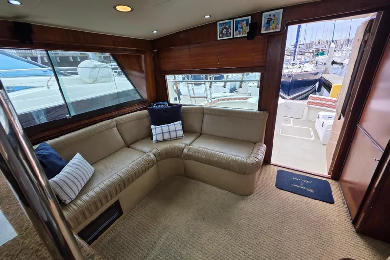 Slide: The Image of Interior of 1987 Hatteras 52 Convertible yacht with beige seating and marina view. - 9