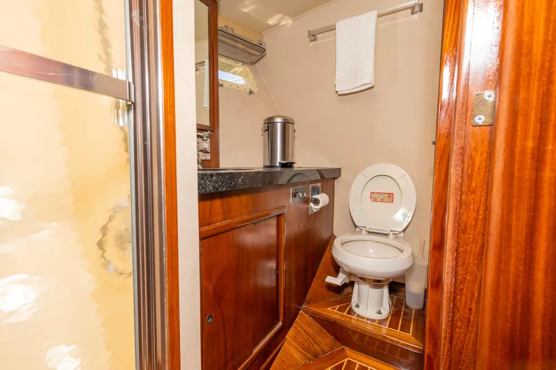 Slide: The Image of Bathroom interior of 1987 Hatteras 52 Convertible yacht with wooden cabinetry and modern fixtures. - 98