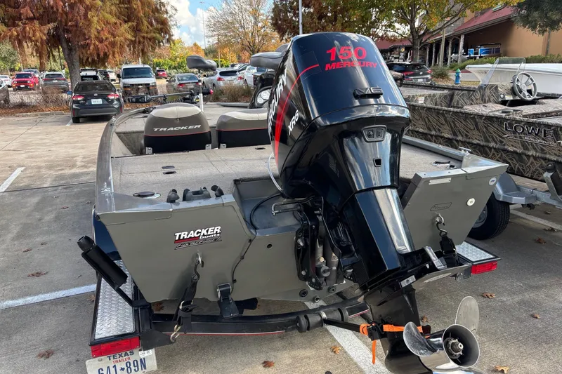 Slide: The Image of 2005 Bass Tracker V18 boat with Mercury 150 XR6 engine in parking lot. - 7