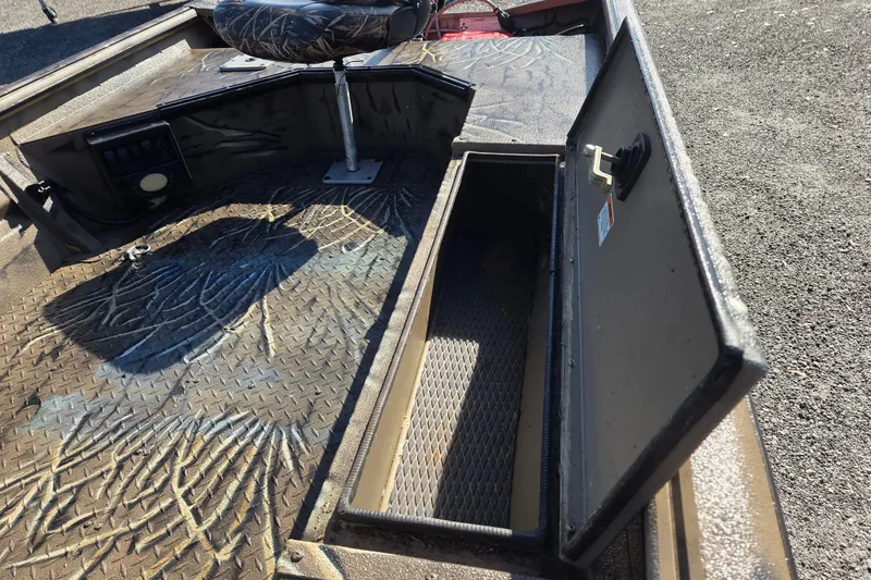 Slide: The Image of 2018 SeaArk DXS 1548 DKLD boat interior with open storage compartment. - 11