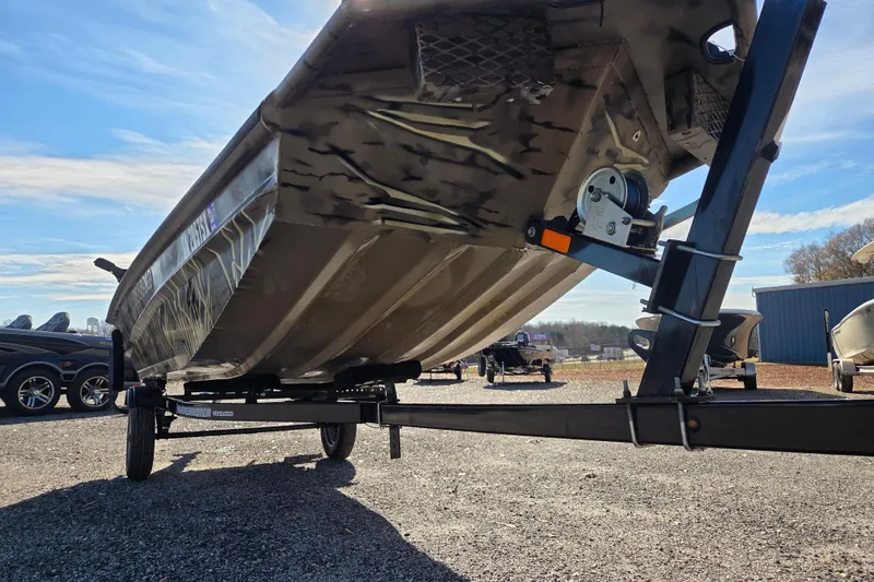 Slide: The Image of 2018 SeaArk DXS 1548 DKLD boat on trailer, parked outdoors. - 3