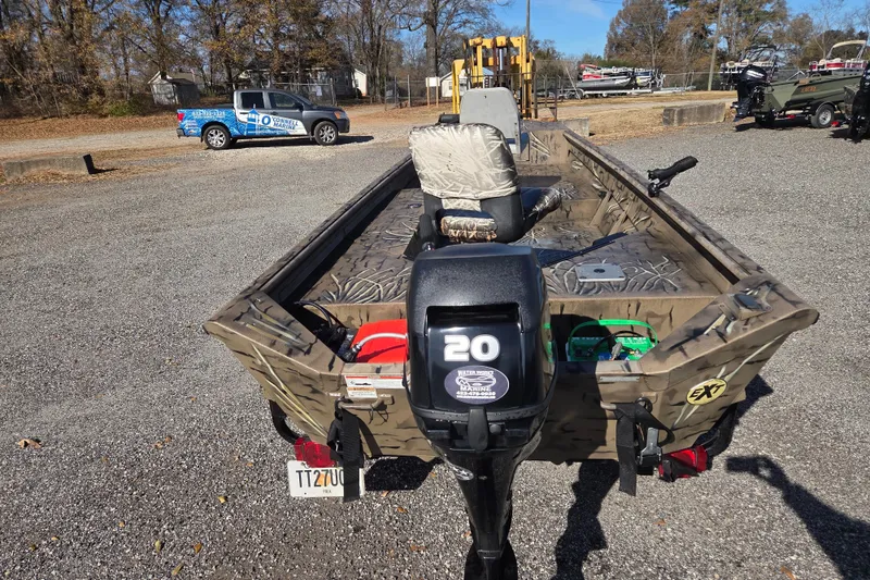 Slide: The Image of 2018 SeaArk DXS 1548 DKLD boat with 20 HP motor in a parking lot. - 6