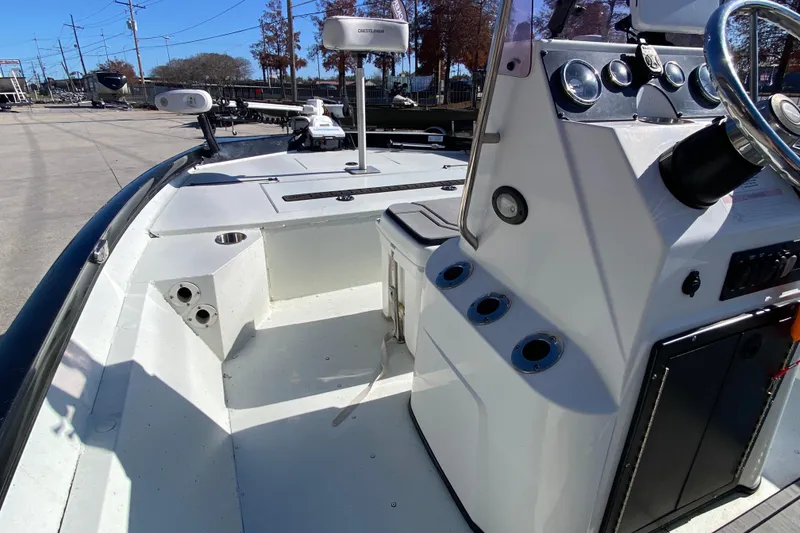 Slide: The Image of 2019 Crestliner 1800 Bay boat interior with steering console and fishing rod holders. - 13
