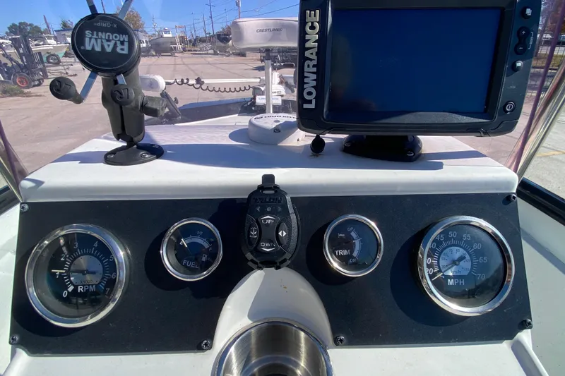 Slide: The Image of Dashboard of a 2019 Crestliner 1800 Bay boat with gauges and Lowrance display. - 16
