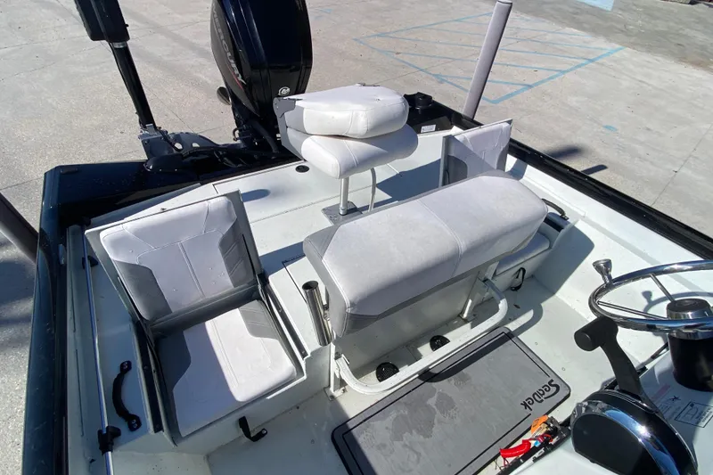Slide: The Image of 2019 Crestliner 1800 Bay boat interior with seating and steering wheel. - 18
