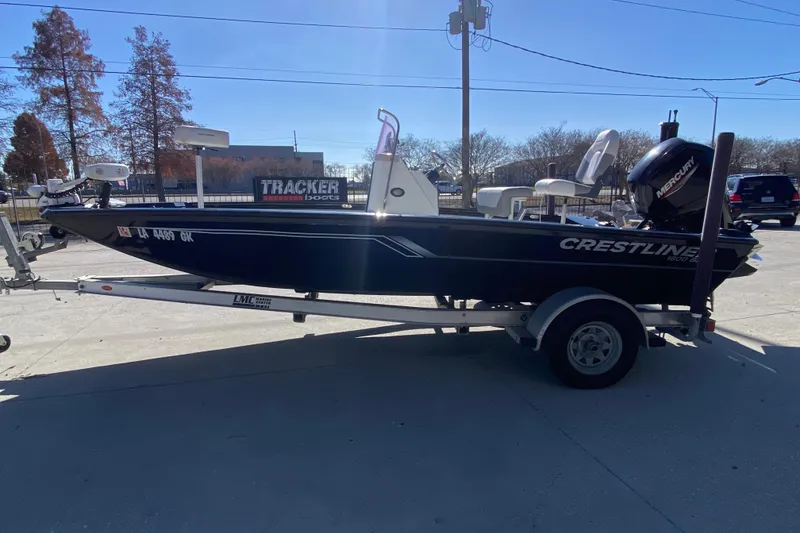 Slide: The Image of 2019 Crestliner 1800 Bay boat on trailer, parked outdoors in sunny weather. - 5