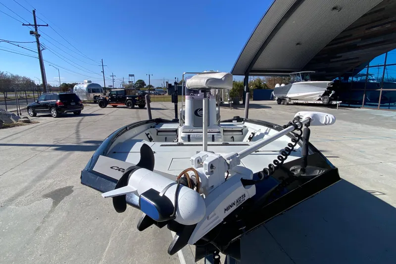 Slide: The Image of 2019 Crestliner 1800 Bay boat with Minn Kota trolling motor in a dealership lot. - 7